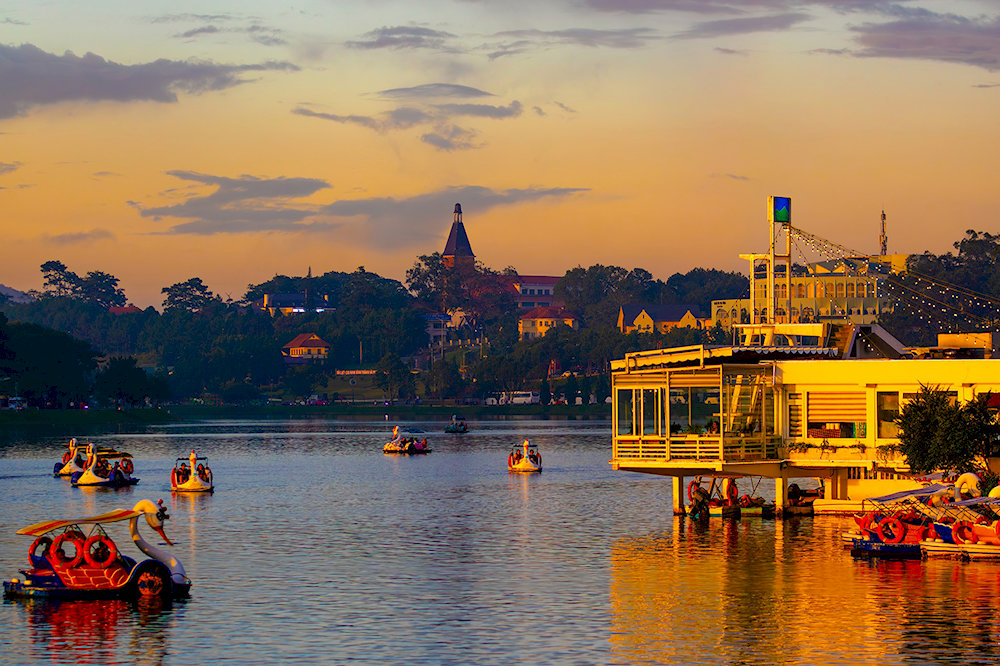 Unwind in peaceful serenity by Xuan Huong Lake, where pine-lined paths, calm waters, and cool mountain air offer the perfect escape in the heart of Da Lat 